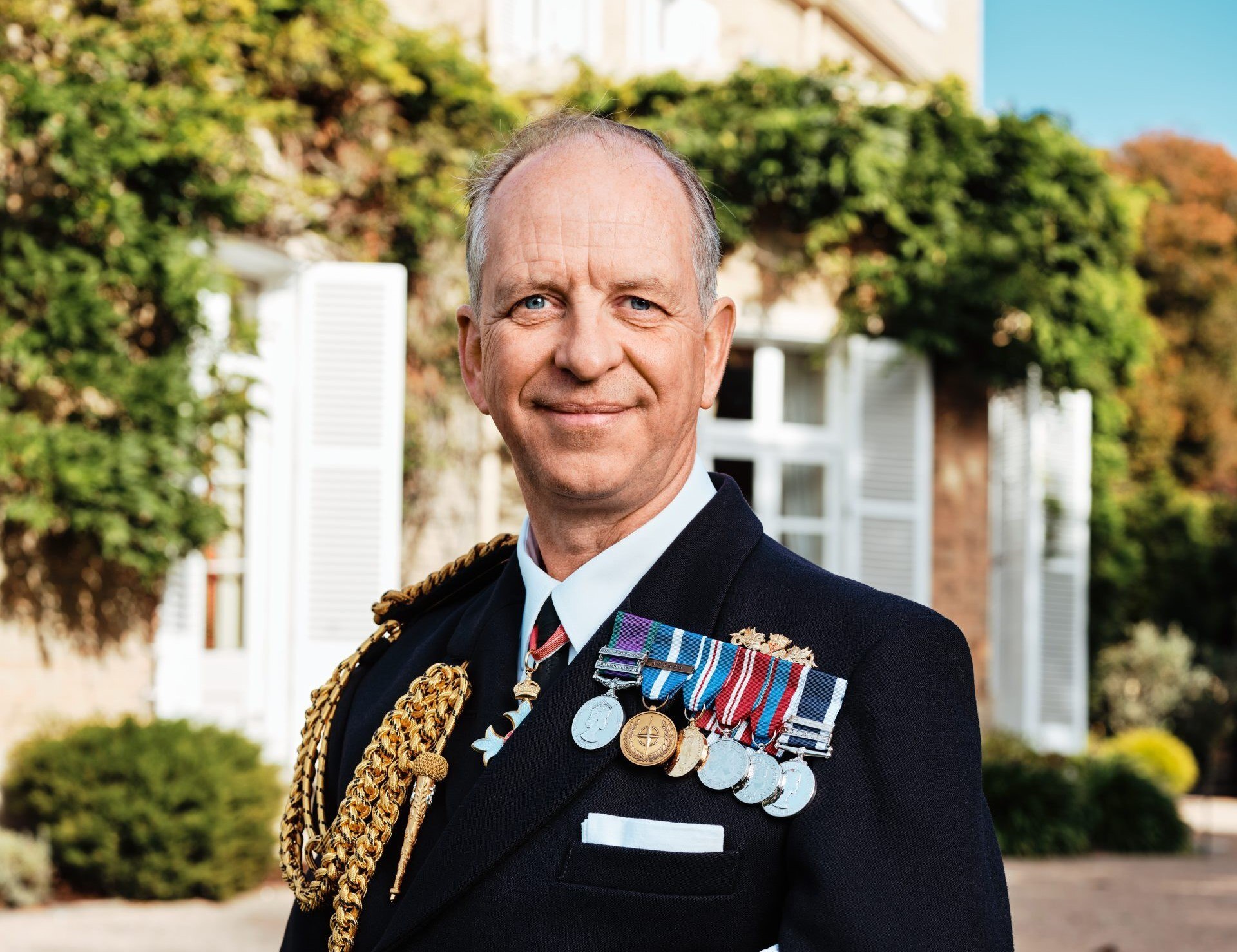 Lieutenant Governor - Vice Admiral Jeremy Kyd. He is wearing smart uniform, with medals on his chest. He is smiling at the camera.