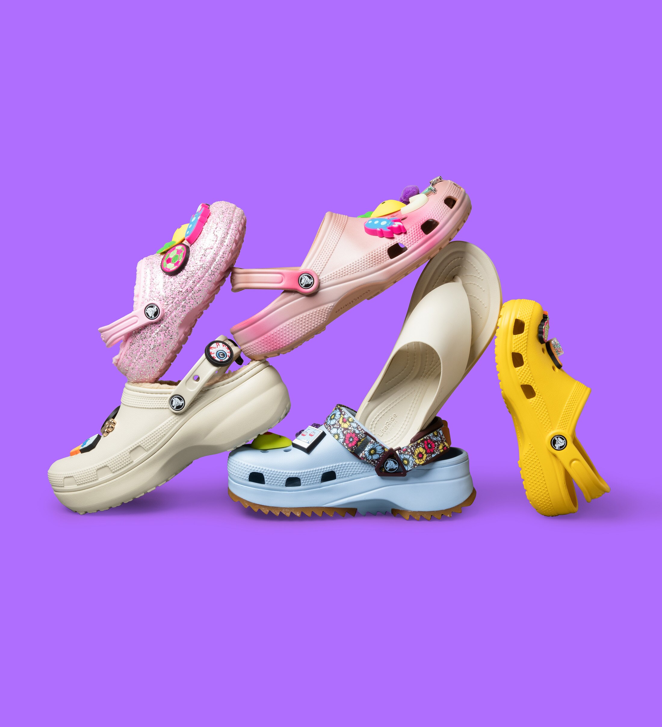 stacked crocs with purple background