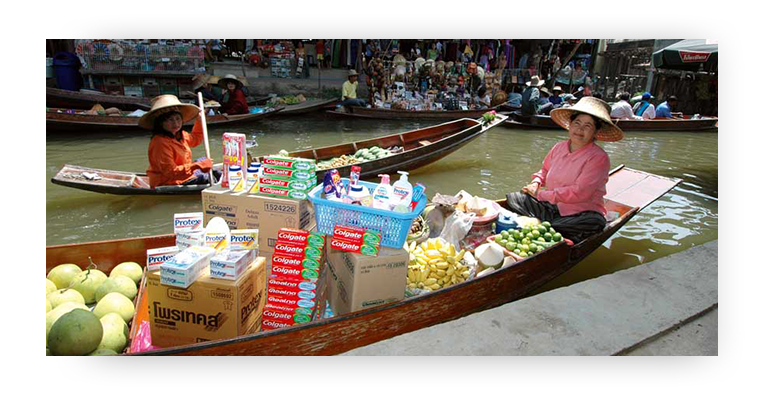 Floating market in Thailand, Asian Woman selling Colgate and Protex from a boat