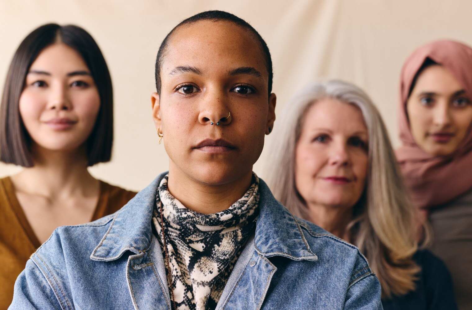 Four diverse females looking forward with serious faces