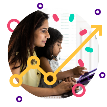 A mother sitting with young child girl working on her laptop screen