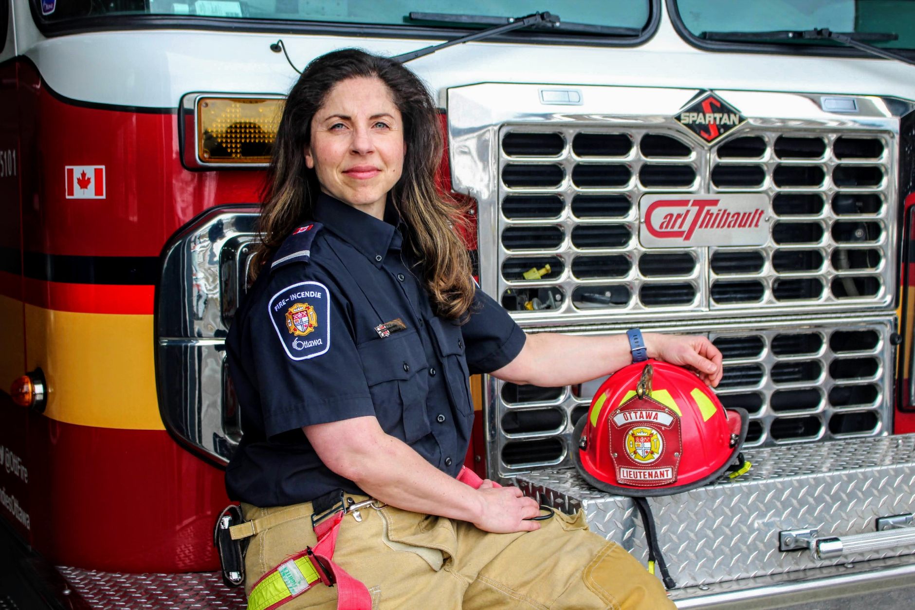  Woman firefighter sitting in front of fire truck