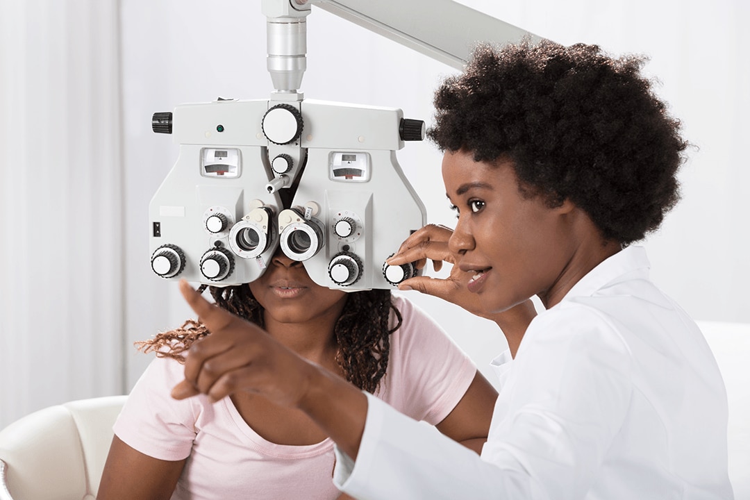 Image of a doctor giving an eye exam to a patient