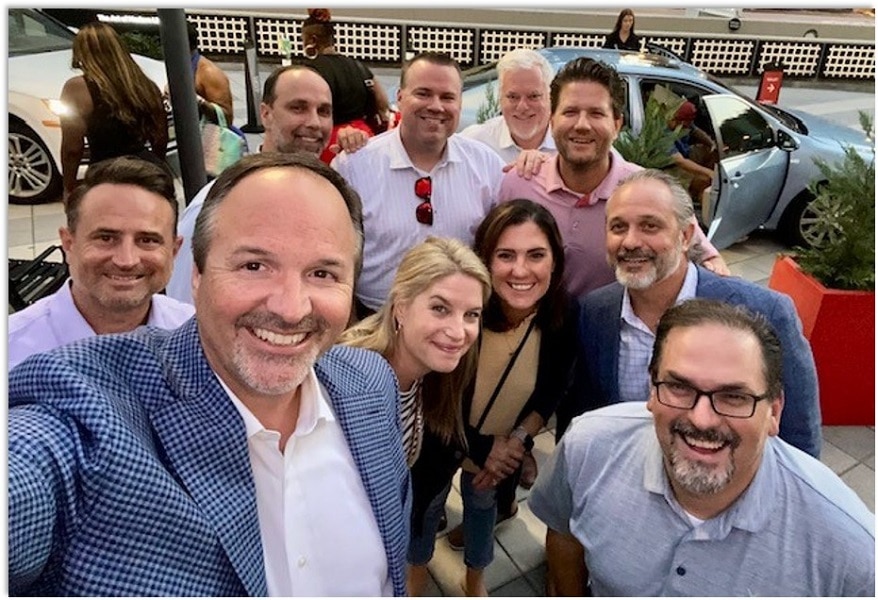 photo of several business leaders talking a selfie