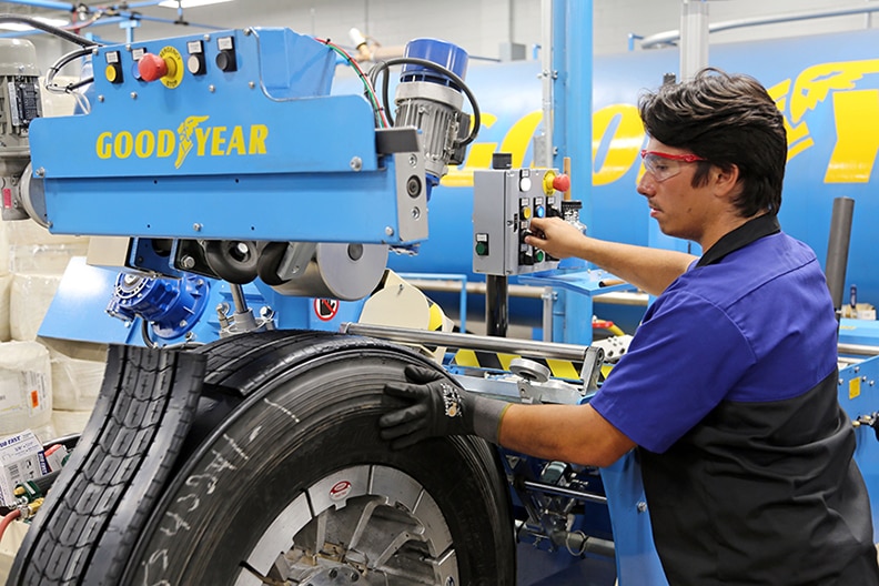 A Goodyear associate retreads a tire