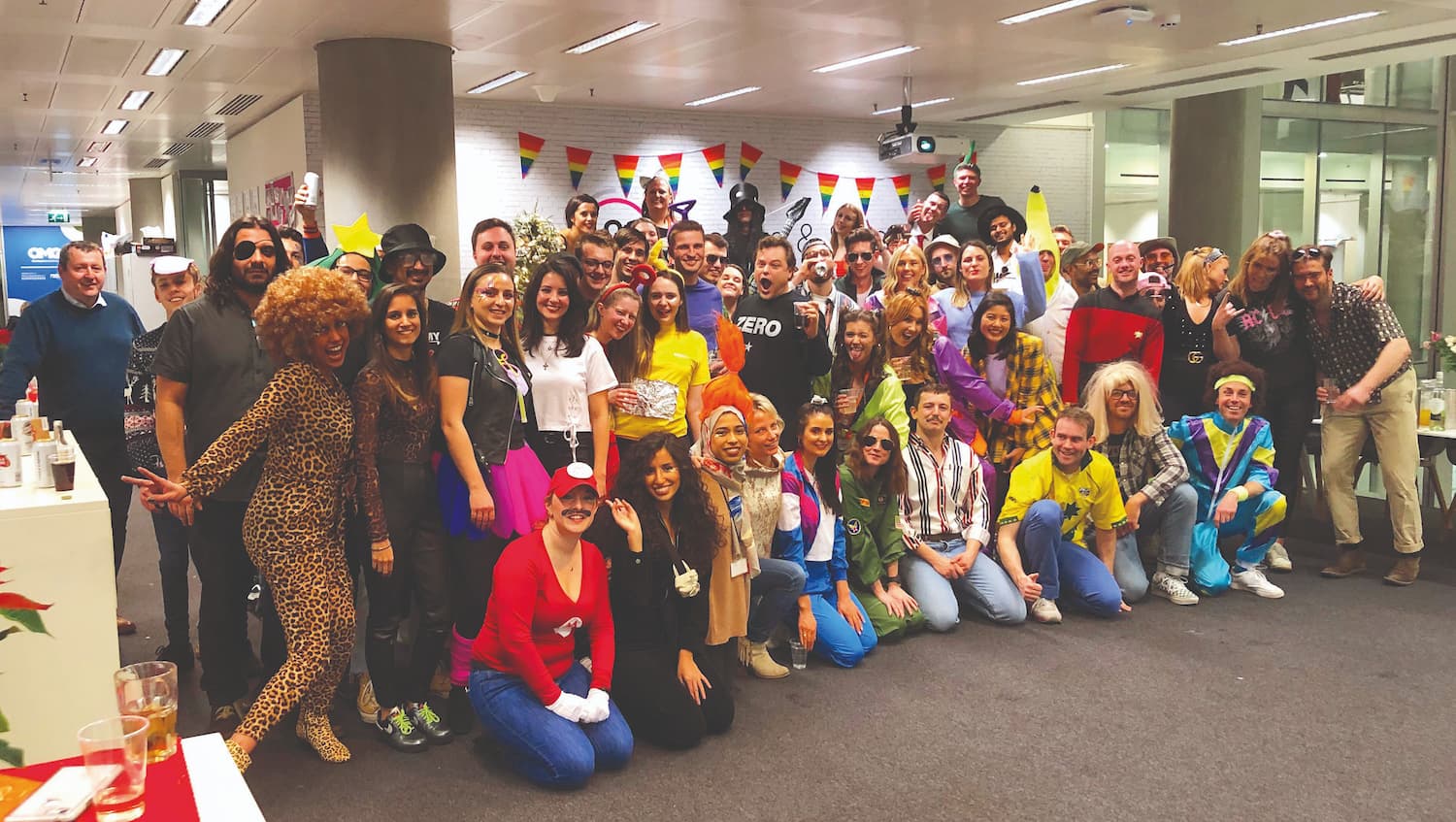 A group shot of agency staff in fancy dress at their Christmas party