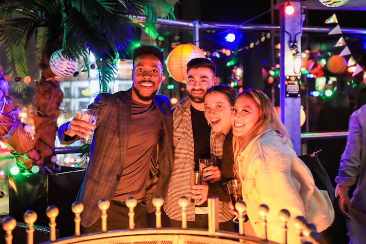 A group of colleagues posing for a photo together at an agency party