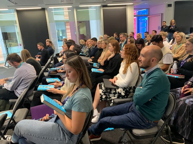 A large group of staff listening to a presentation