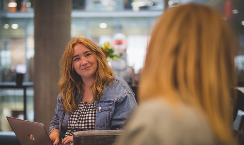 Two colleagues having a conversation in an informal area in their office
                                        Learning & development: A man sat at a table at home with his laptop ready to engage in online training