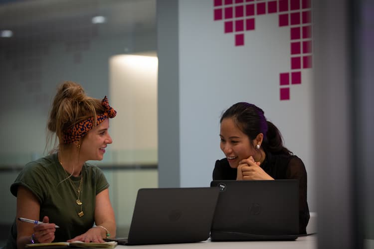 Two colleagues in conversation in a work setting