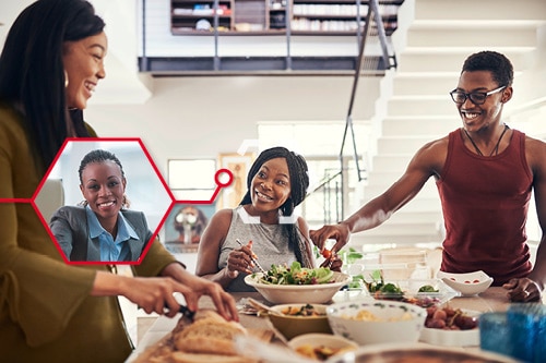 Three young adults are sitting and standing around a table, chatting and preparing food. One of them can also be seen in a smaller picture at the office.