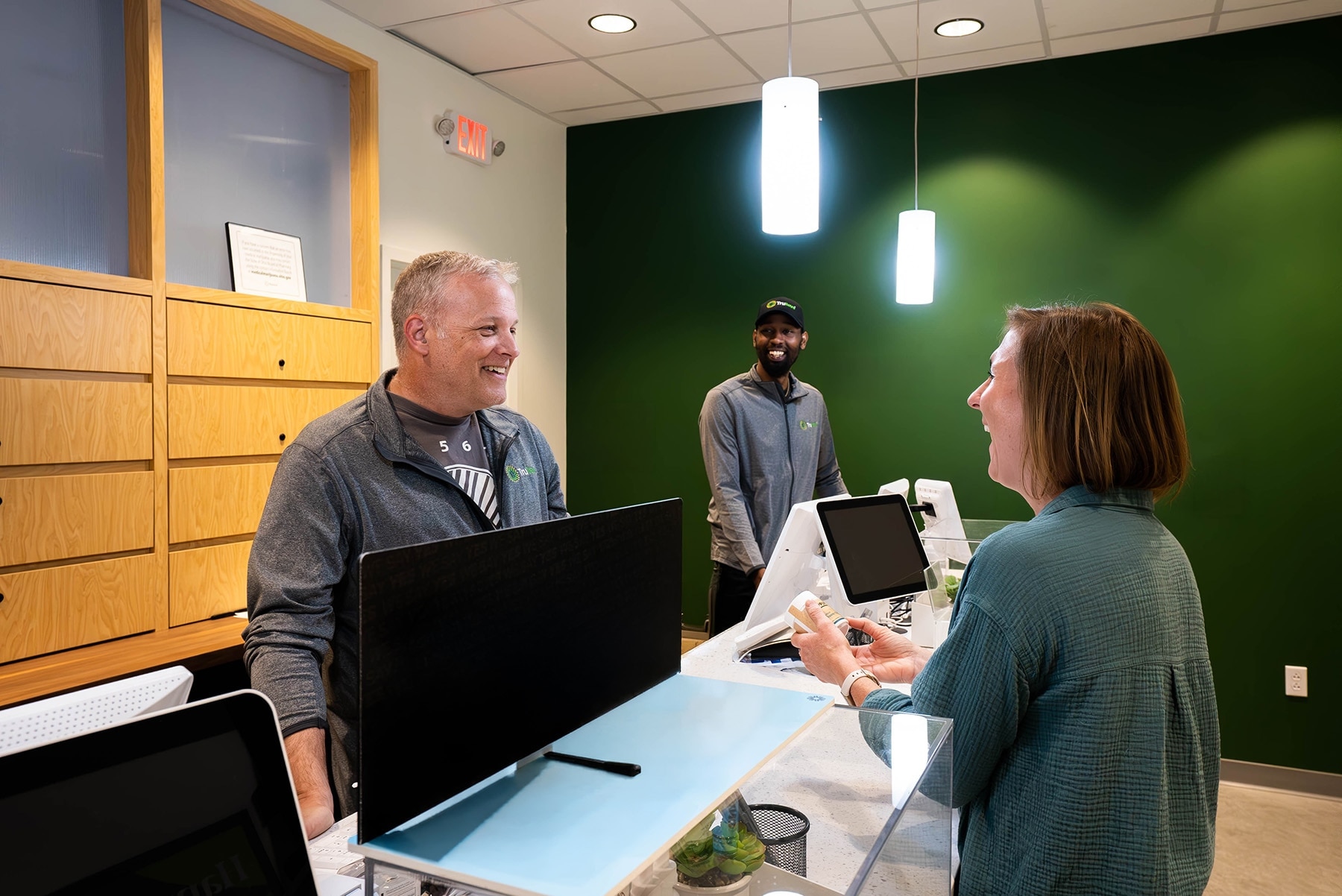 Trulieve team members helping a customer at a dispensary counter
