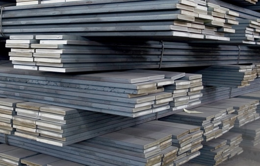Picture showing stacks of steel flat bar product.