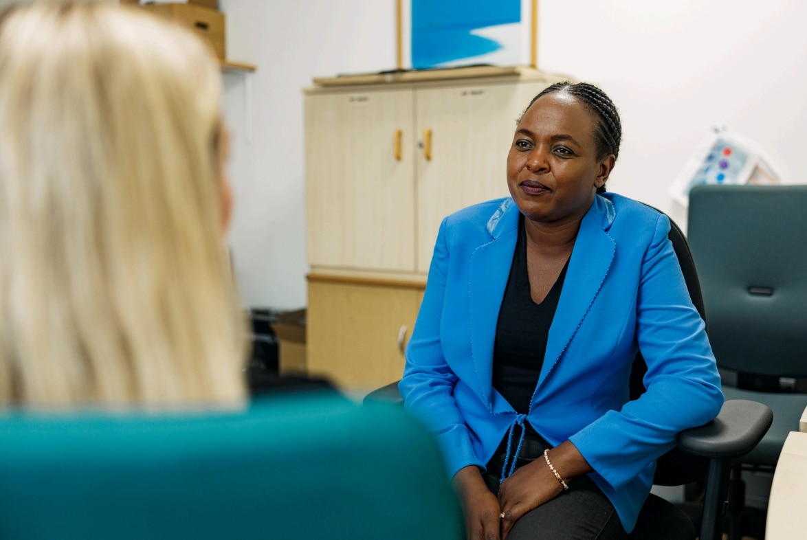 Two people having a conversation in an office.