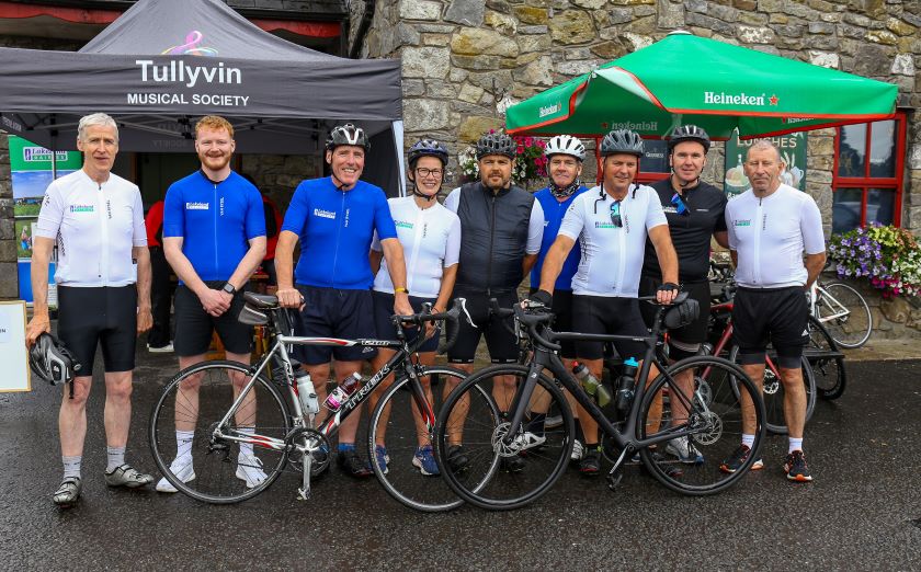 A group of employees in cycling gear with their bicycles