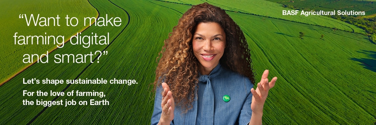 A person with long curly hair, wearing a blue jacket, stands in front of a green agricultural field. Visible English text reads: Want to make farming digital and smart?‘, ‚Let's shape sustainable change.‘, ‚For the love of farming, the biggest job on Earth‘ and ‚BASF Agricultural Solutions