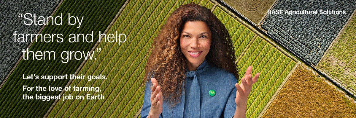 A person with curly hair and raised hands is wearing a blue shirt with a green pin. Aerial shots of agricultural fields with various crops can be seen in the background. Visible English text reads: Stand by farmers and help them grow.‘, ‚Let's support their goals. For the love of farming, the biggest job on Earth.‘ and ‚BASF Agricultural Solutions‘.
