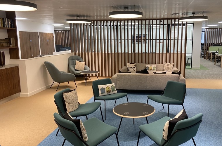 An open plan seating area with chairs and sofas.