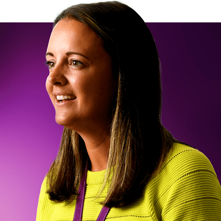 A colleague smiling in a meeting.