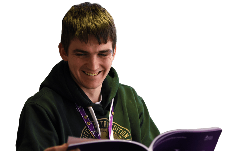 A colleague smiling and reading.