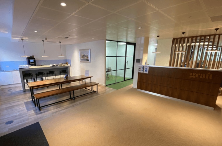 A kitchen area with benches in an open plan office.