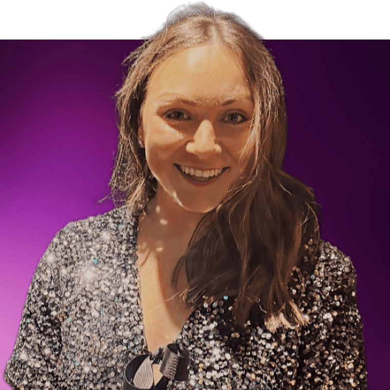 A colleague with brown hair wearing a black and sequin shirt smiling.