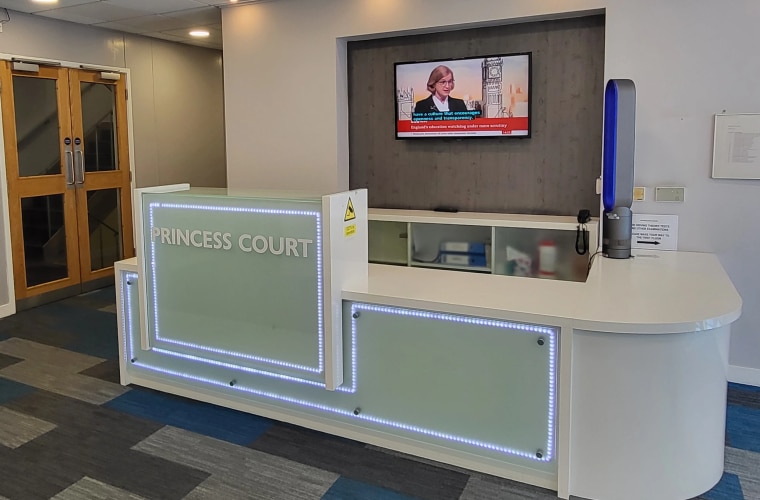 A reception desk with LED lighting.