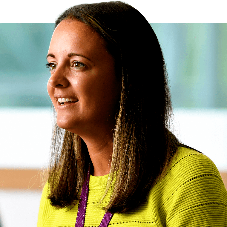 A colleague smiling in a meeting.