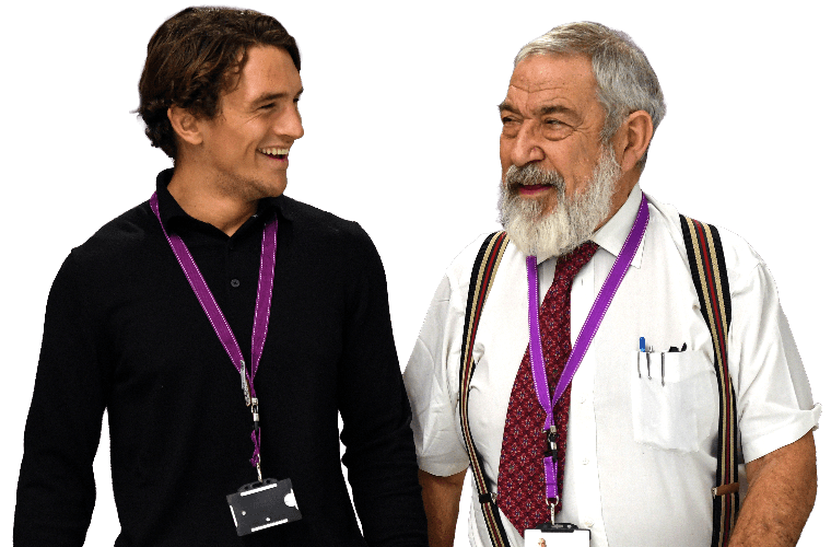 Two colleagues walking together and smiling.