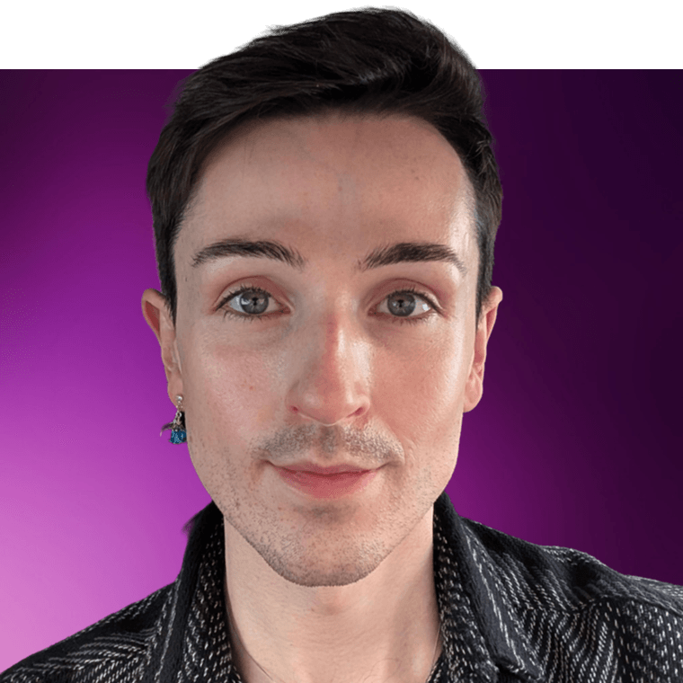 A colleague with brown hair wearing a dark coloured shirt and a single earring in one ear.