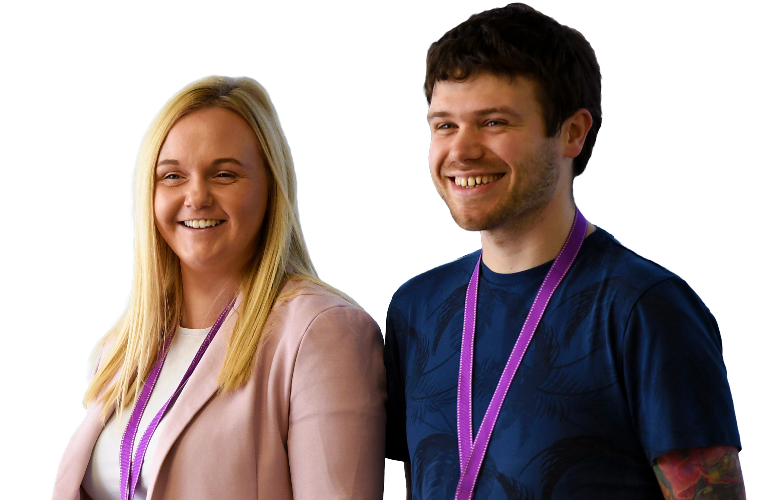 Two colleagues walking together and smiling.