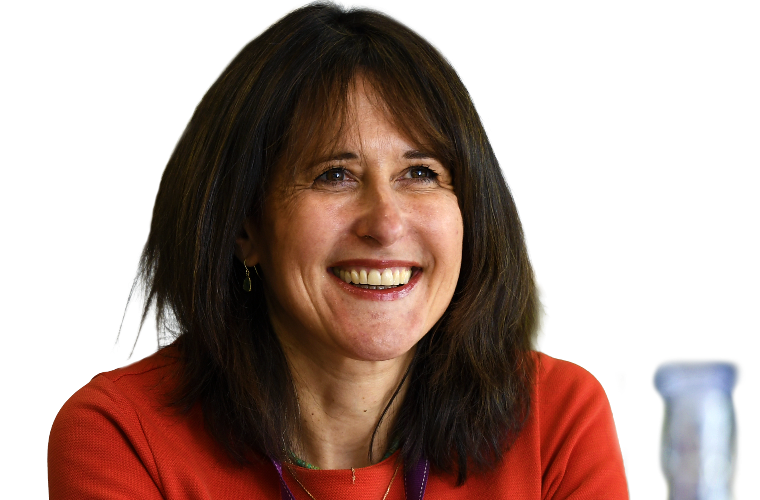 A colleague looking up and smiling in a meeting.