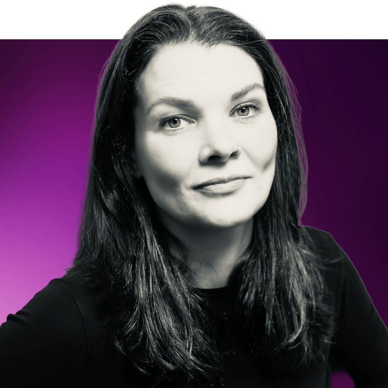 A black and white photo of a colleague with long dark coloured hair wearing a black top.