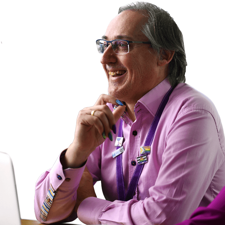 A colleague smiling with rainbow painted nails.