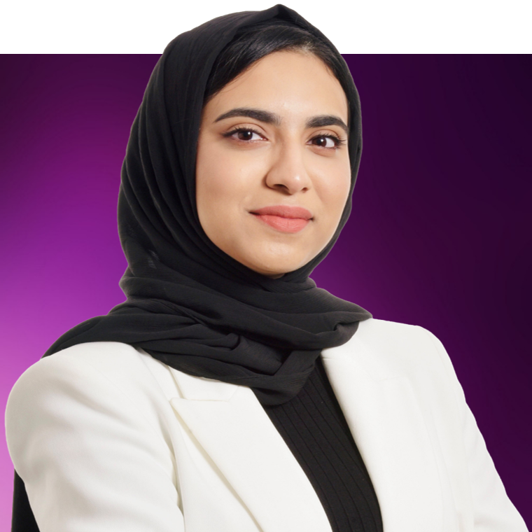 A colleague wearing a black hijab and a cream blazer.