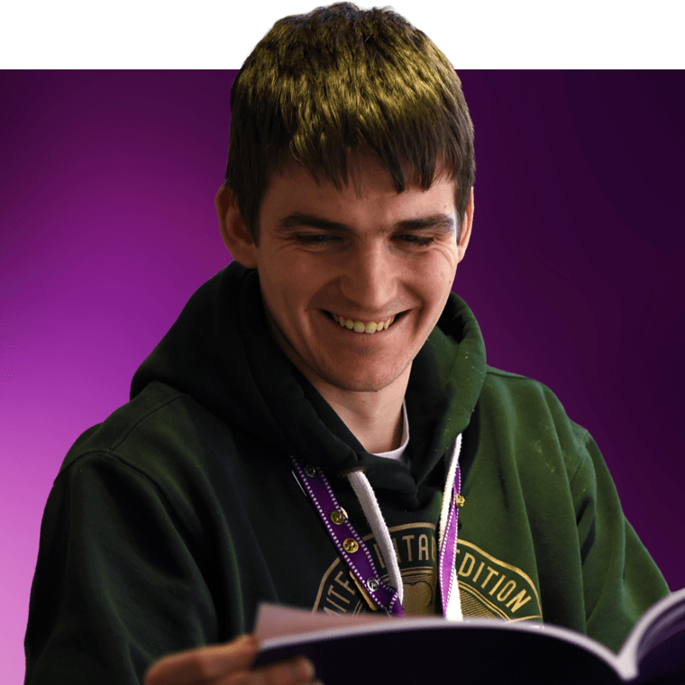 A colleague smiling and reading.