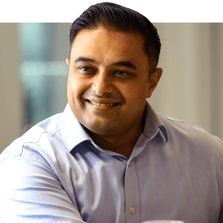 A colleague smiling in a meeting.