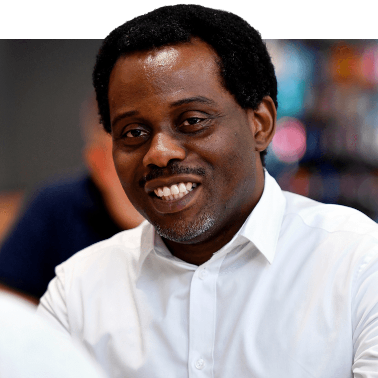 A colleague with black hair wearing a white shirt, smiling.