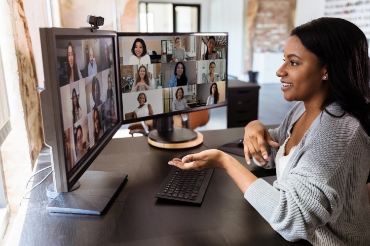  woman teleconferences to meet with her diverse colleagues