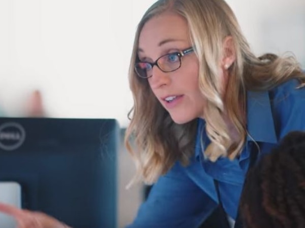 PG&E employee at a monitor points to her screen