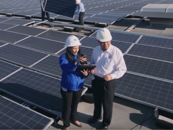 PG&E employee reviews plans with customer on solar rooftop