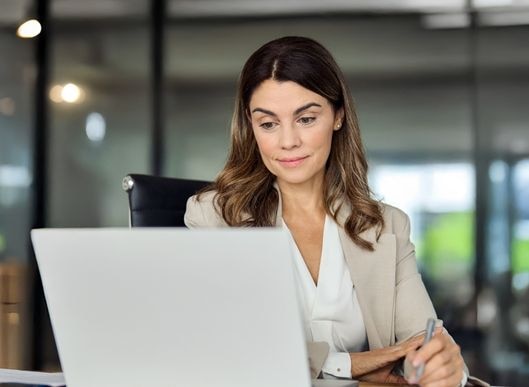 Woman working on a laptop at a table