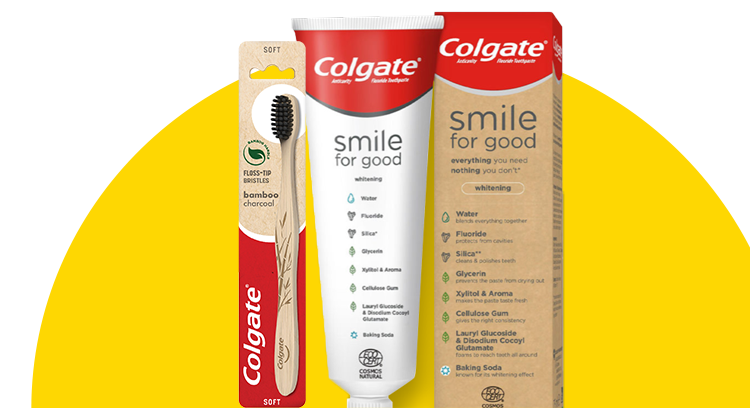 A tube of Colgate's sustainable toothpaste, called "Smile for Good" and it's box and Colgate's bamboo charcoal toothbrush on a yellow background