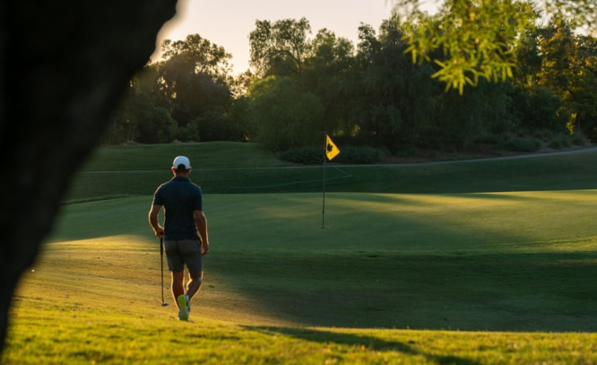 Man walking down a golf course