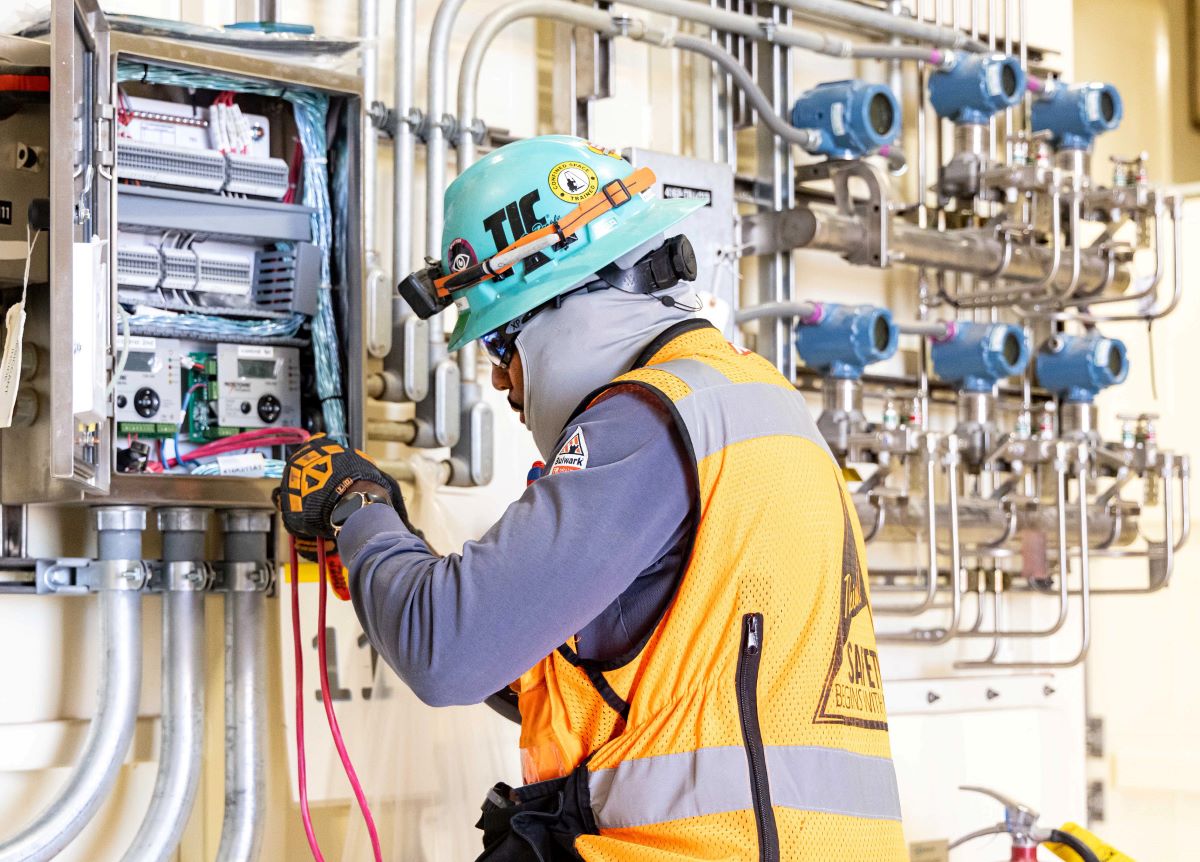 TIC employee working on machinery