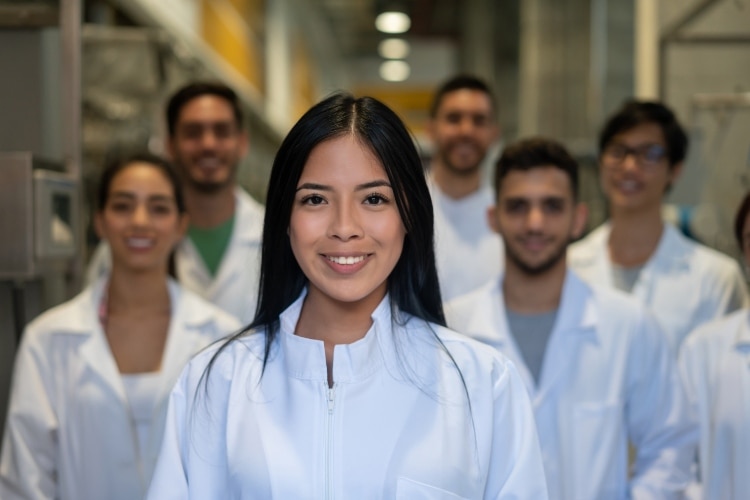 A group of engineers in white lab coats