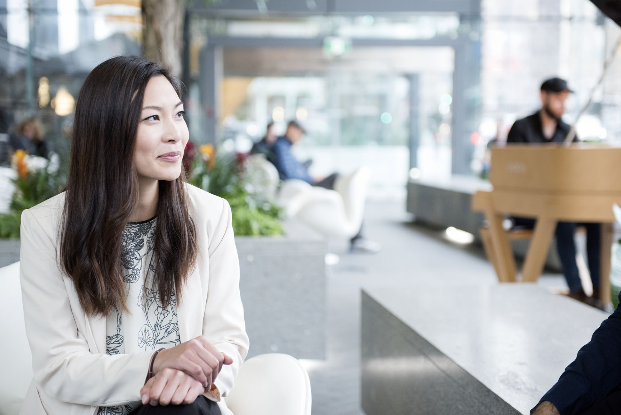 A team member sits in the lobby of TELUS Garden and looks into the distance