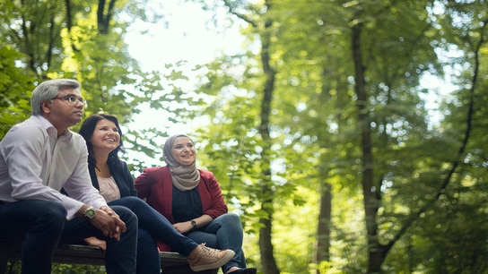 3 Allianz employees sitting outdoors in a casual setting 
