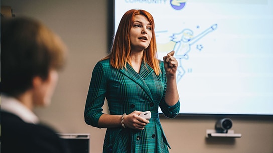 An image of a woman giving a presentation