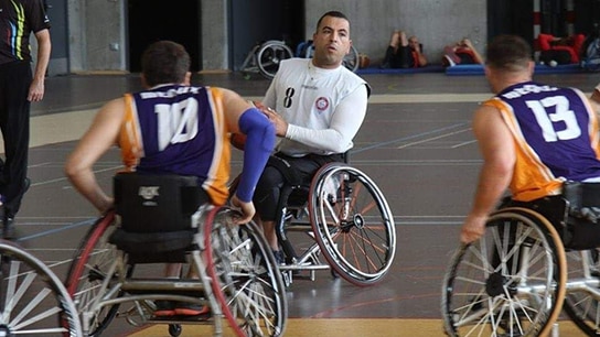 An image showing people playing wheelchair basketball